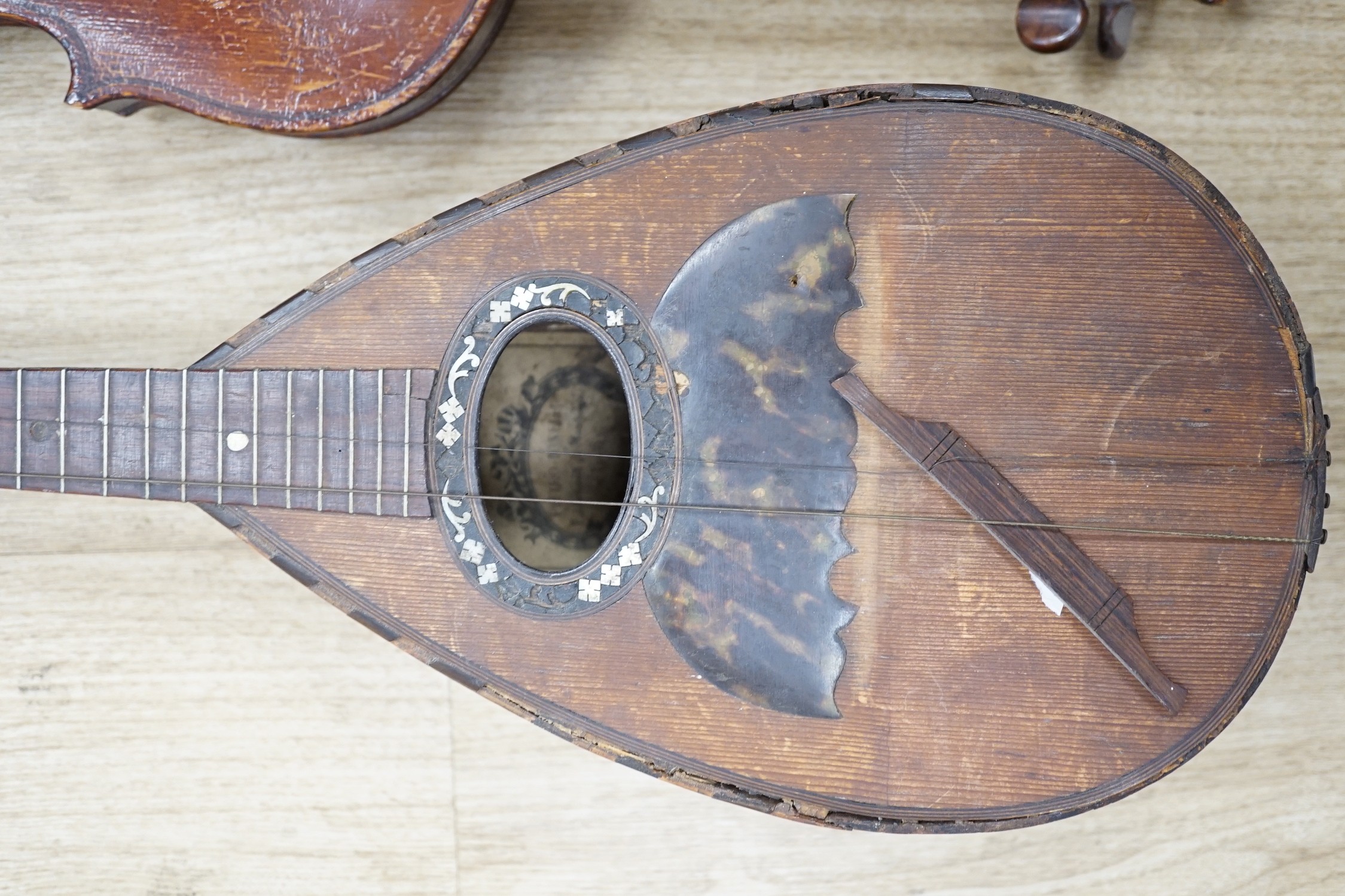 An Italian balloon back mandolin with tortoiseshell overlay, circa 1900, label for Pietro Tonelli of Napoli together with a violin, interior hand label reads ‘A.J. Newland London SW12 1939’ length of violin back excludin